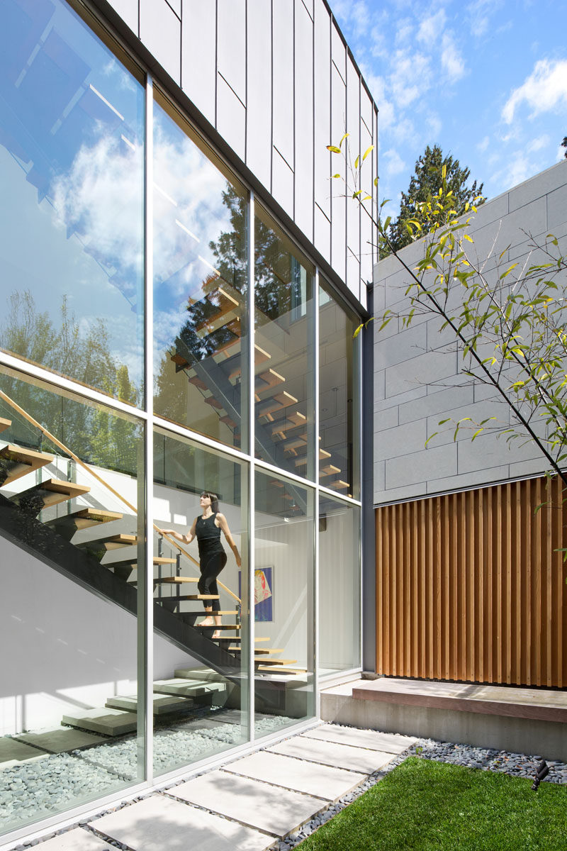 Large double height windows flood the stairs with natural light.