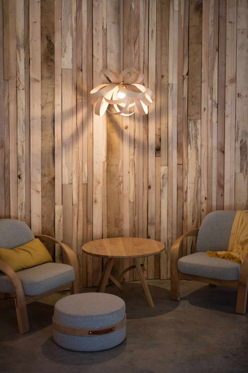 Wooden walls made from various thickness' of wood make for a creative wall design for this small sitting area.