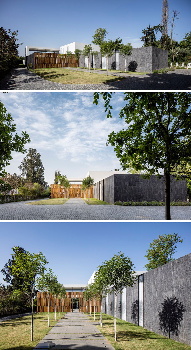 A tree lined path leads you to the entrance of this home.