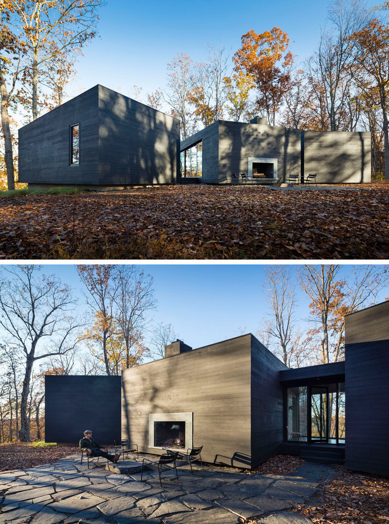 Upon arriving at this house, you are greeted by stone paved outdoor area focused on a fireplace built into the design of the house.