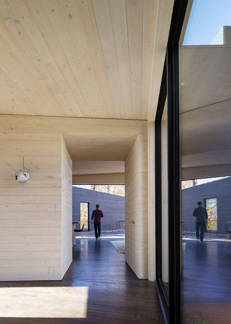 Black window frames provide a strong contrast between the light wood used on the walls and ceiling.