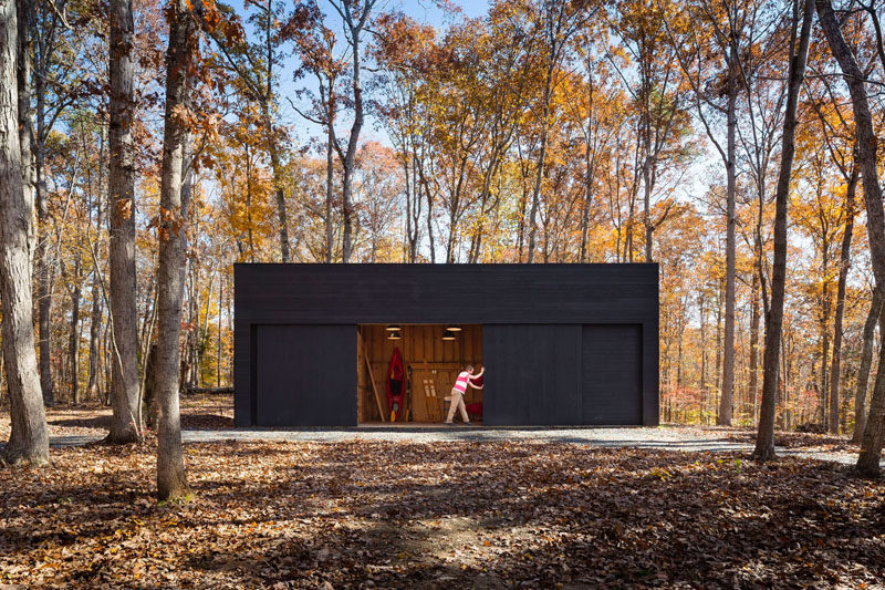 This home in a wooded area has a separate garage/studio that matches the design of the house.