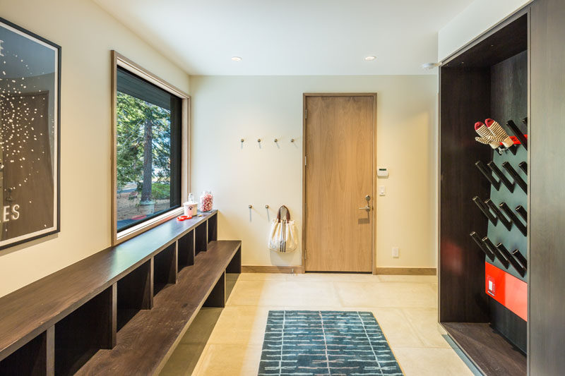 This mudroom has a built-in bench and a drying rack for wet shoes, gloves and jackets.