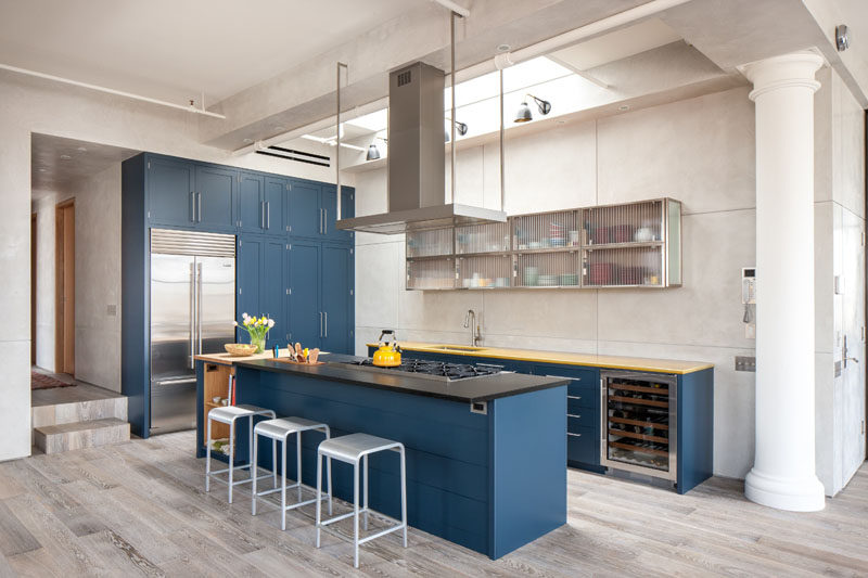 Kitchen Design Ideas - Deep Blue Kitchens // The blue cabinets are lightened up by the skylight above the kitchen and the neutral walls and light wood floors.