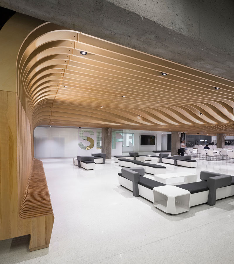 Interior Design Ideas - The wooden seating in this student center continues up the wall and becomes the ceiling.