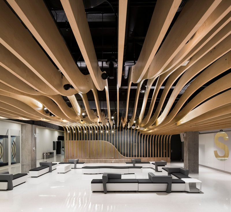 Interior Design Ideas - The wooden seating in this student center continues up the wall and becomes the ceiling.