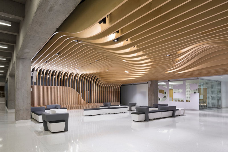 Interior Design Ideas - The wooden seating in this student center continues up the wall and becomes the ceiling.