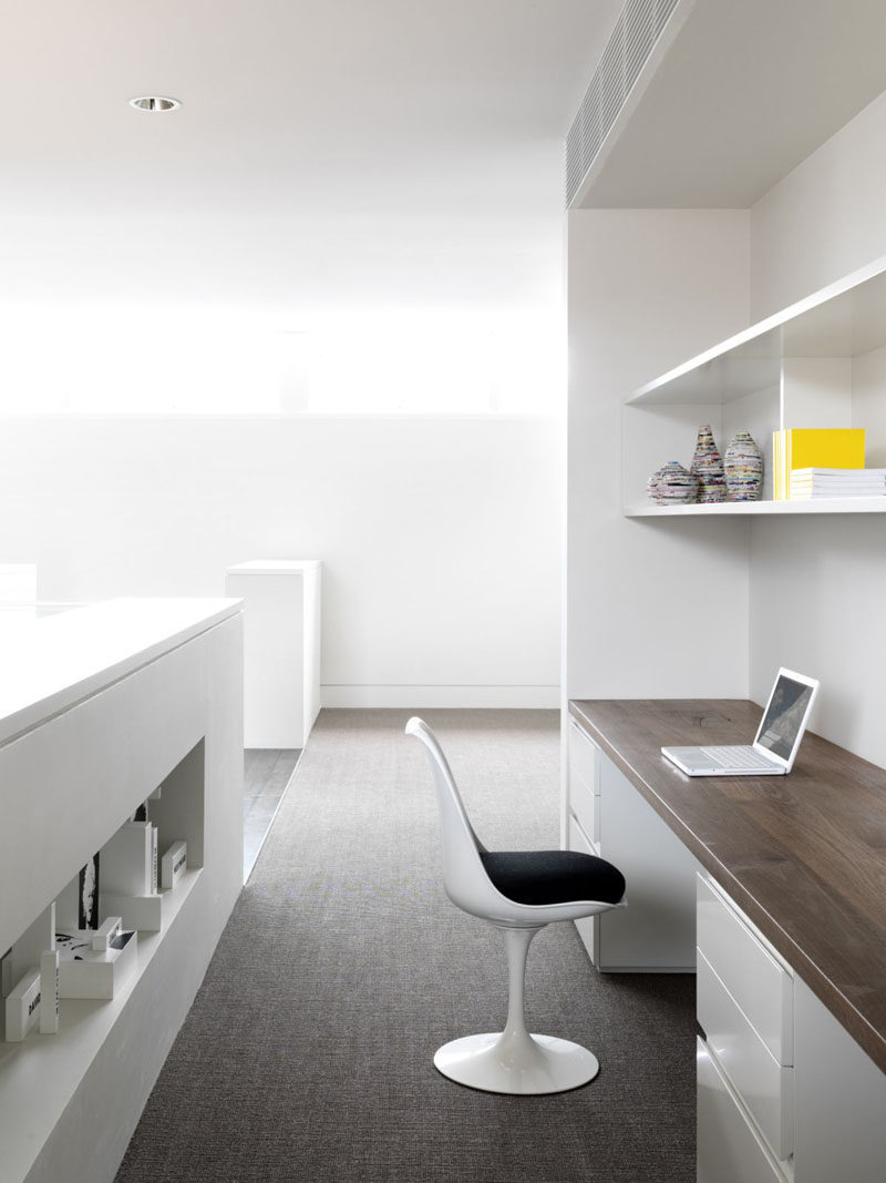 Interior Design Idea - 13 Examples Of Desks In Hallways // A large home office sitting at the top of the stairs has lots of work space, ample storage solutions, and a warm wood desk top to make the spot feel cozy and inviting.