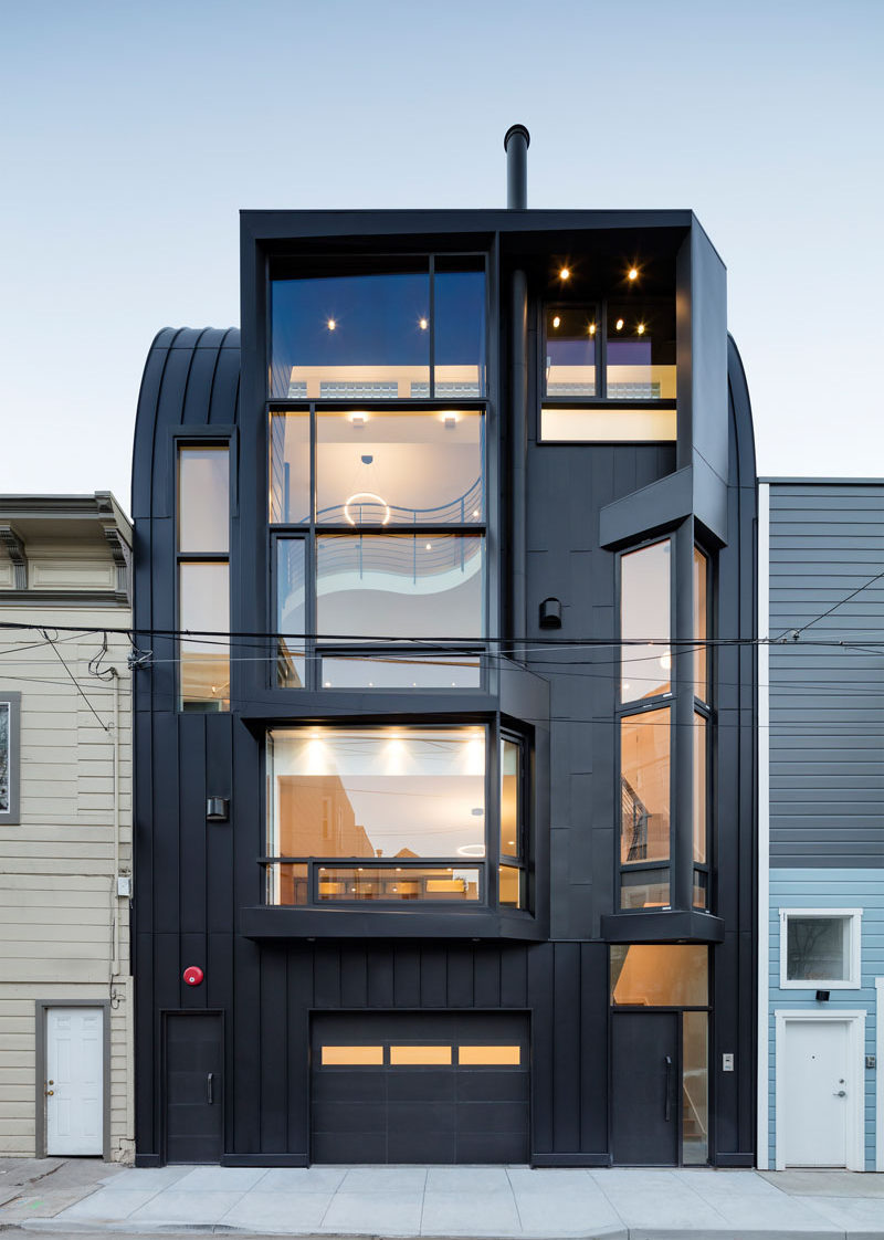 Designed by Stephen Phillips Architects, this black apartment building in San Francisco, is in a mixed-use commercial and residential district, that incorporates an eclectic group of traditional one- to four-story Victorian and Edwardian houses.