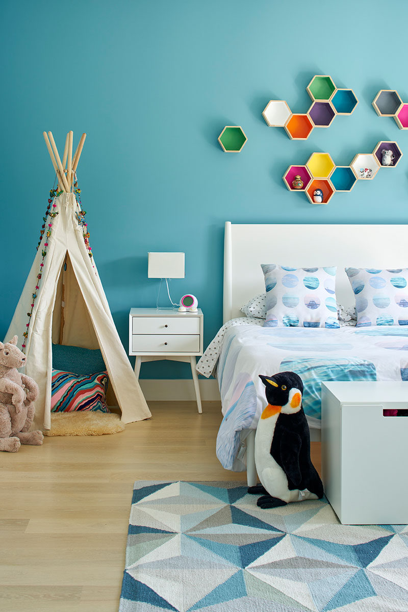 This kids bedroom is full of colour, especially the floating hexagon shelves.