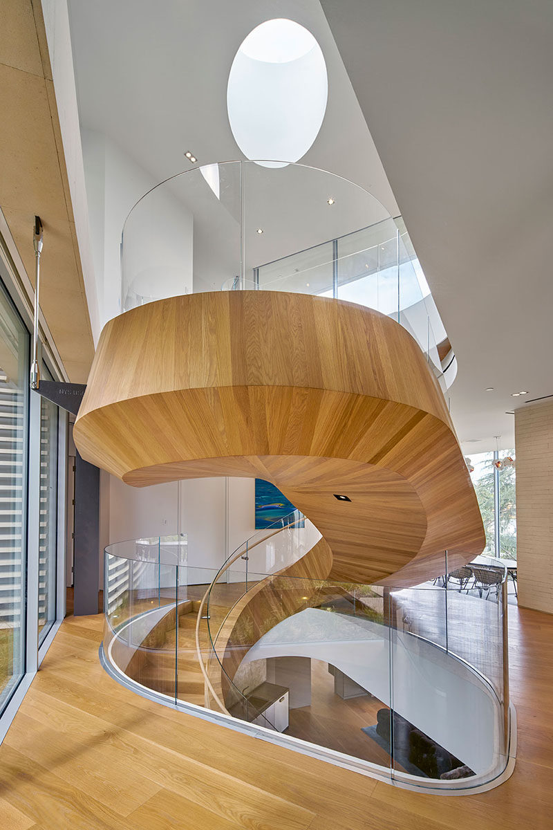 A sculptural wood spiral staircase welcomes visitors to this house in Los Angeles.