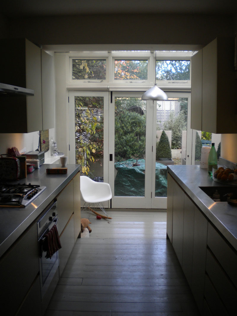 A skylight and white paint could be used to brighten this kitchen. Click through to see the renovated space.