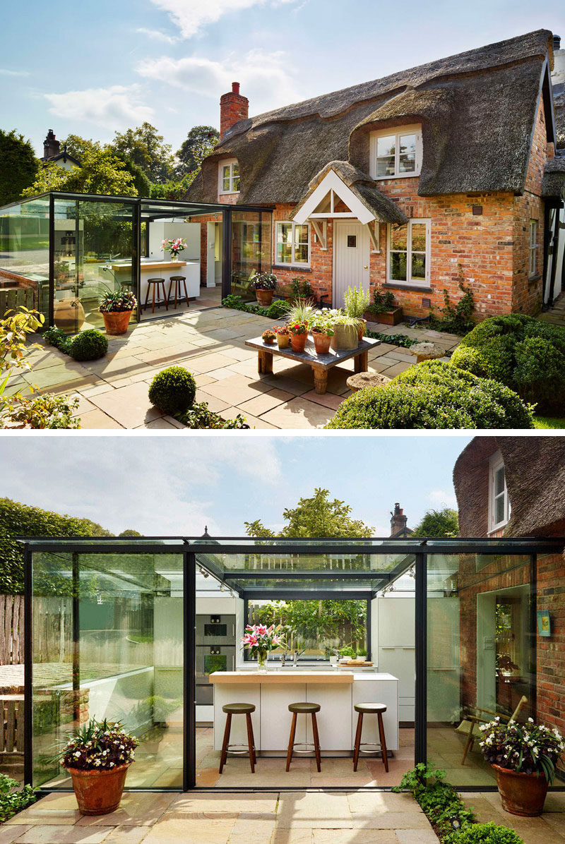 14 Examples Of British Houses With Contemporary Extensions // The thatched roof on this cottage may not be the most modern material, but the glass box extension helps modernize this traditional British home.