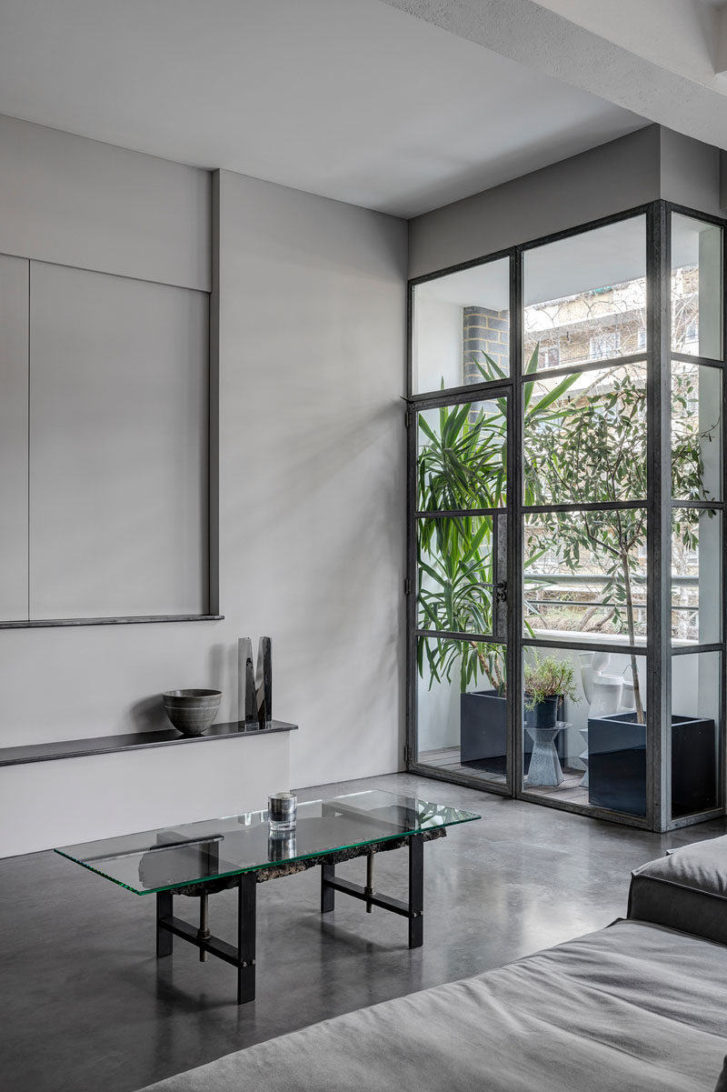 This balcony has been filled with plants to add a touch of greenery to an industrial apartment.