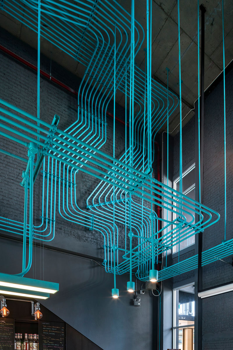 Interior Decor Idea - Turquoise electrical conduit is a design feature running through this co-working office space.