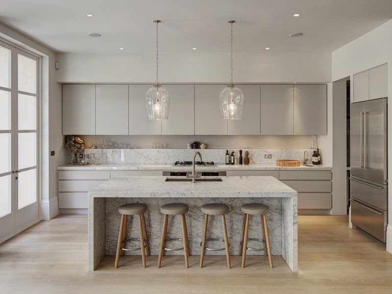 Kitchen Design Idea - How To Add Marble In Your Kitchen // Light grey kitchen cabinets compliment the flecks in the marble and create a sophisticated feel in this bright and airy kitchen.