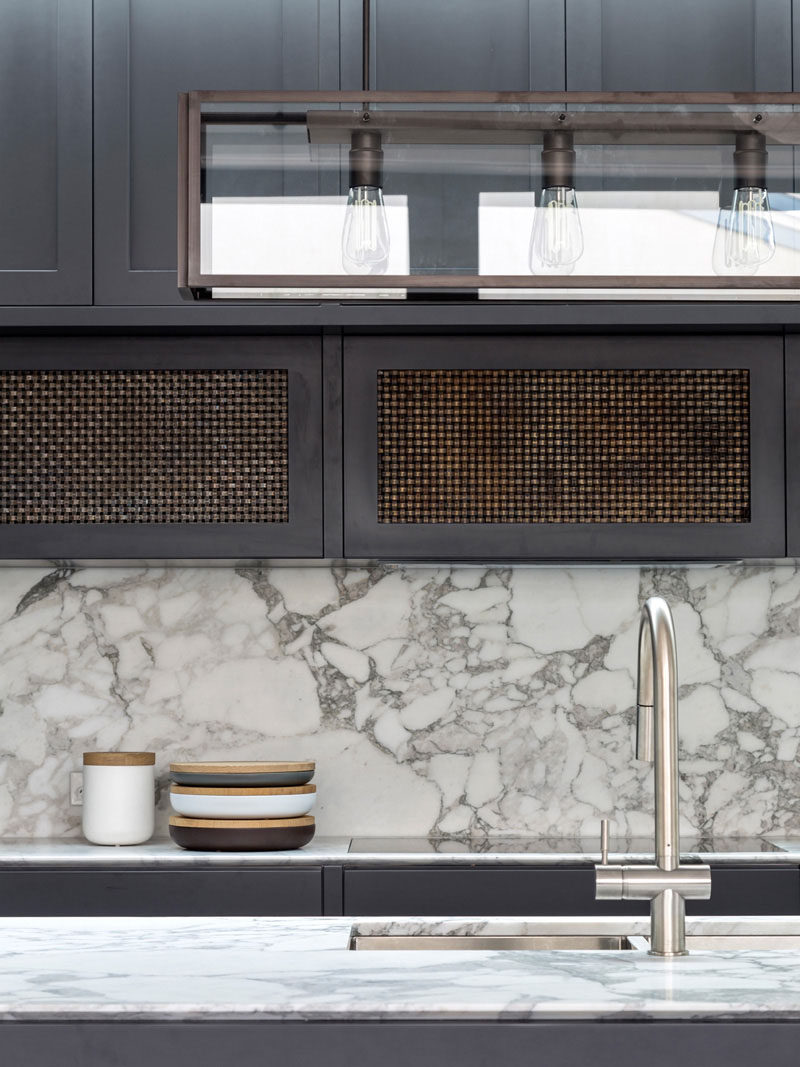 Kitchen Design Idea - How To Add Marble In Your Kitchen // There's an industrial modern feel in this kitchen created by the Edison bulbs in the steel light fixture and the marble backsplash / countertops on both the island and the back wall.