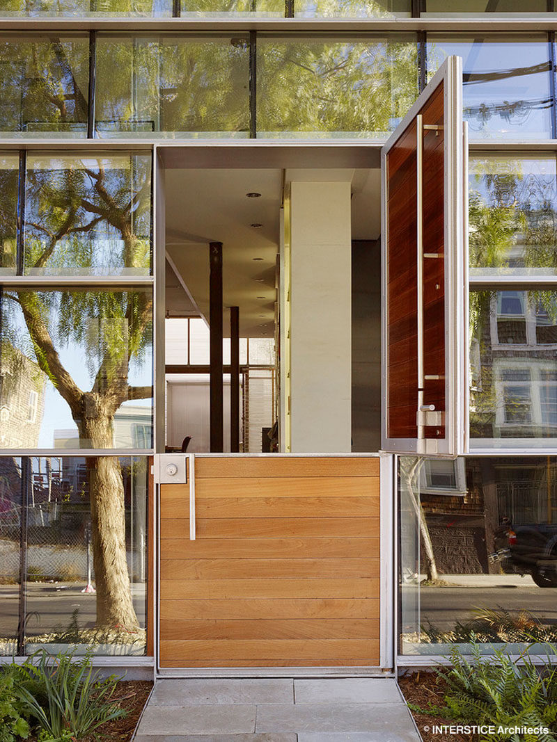 Door Design Ideas - 9 Examples Of Modern Dutch Doors // This modern Dutch door, surrounded by walls of windows, opens up the front of the home and allows in natural light and lets fresh air flow into the home.