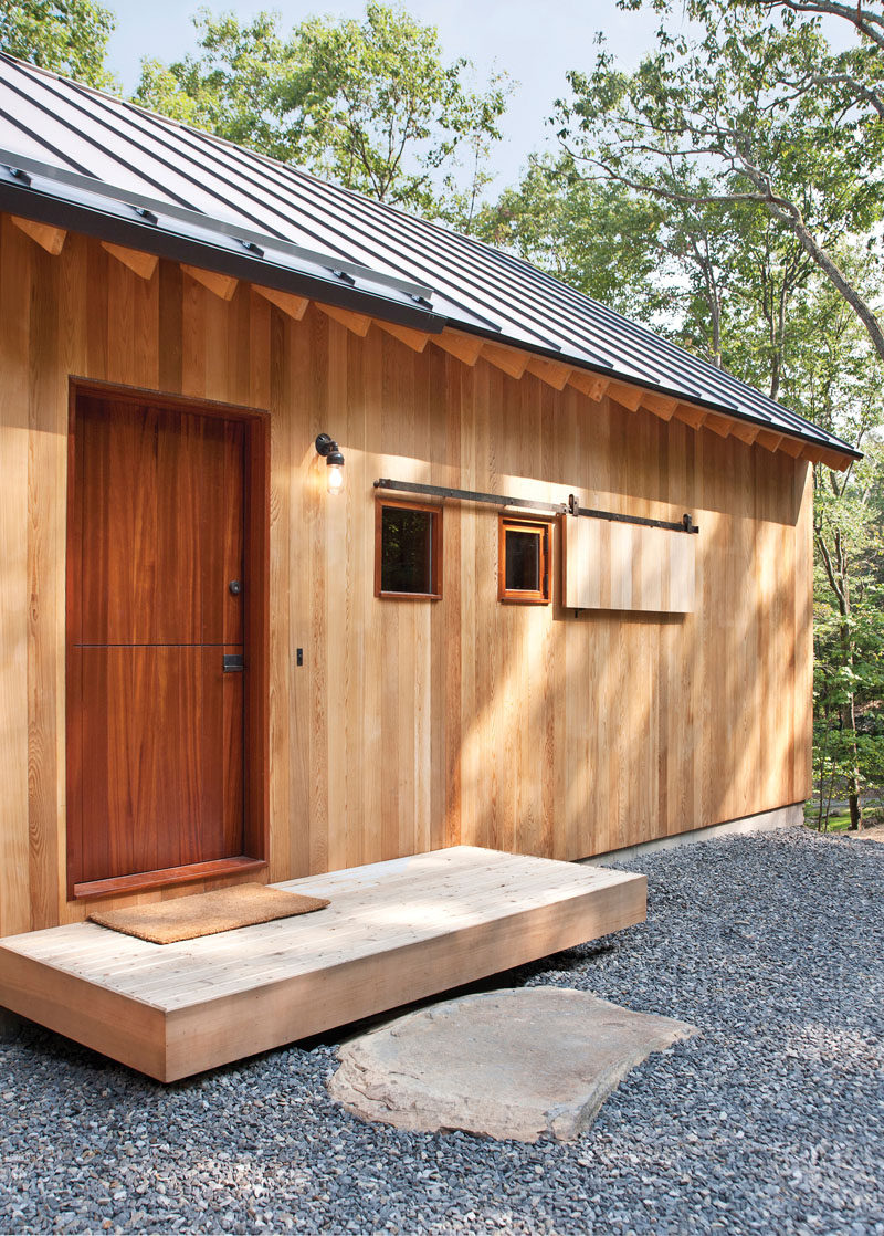 Door Design Ideas - 9 Examples Of Modern Dutch Doors // This dark wood Dutch door is the entrance to the guest house located just off the luxurious main home tucked into the forest.