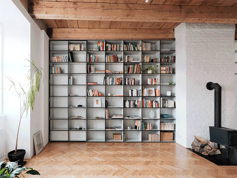 A bedroom hides behind this bookcase and is accessed through a secret door