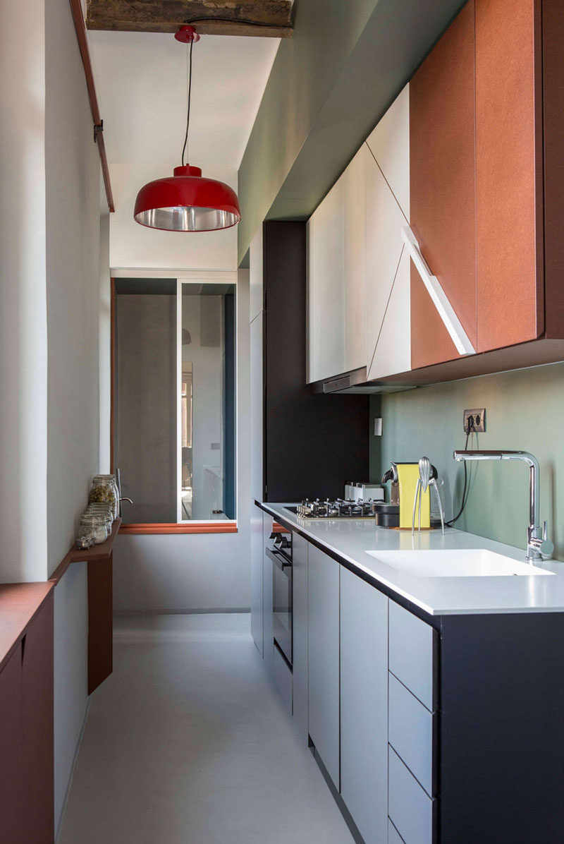 Kitchen Design Ideas - 14 Kitchens That Make The Most Of A Small Space // Subtle colors and natural light coming into this small kitchen help make it feel bright, airy, and clean. Tall cabinets on one wall add storage and a small built-in shelf on the opposite wall provides a place for storing spices.