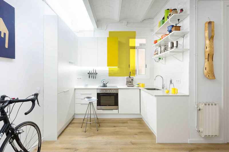 Kitchen Design Ideas - 14 Kitchens That Make The Most Of A Small Space // White walls and a rectangular pop of yellow help brighten this kitchen and make it feel larger than it actually is.