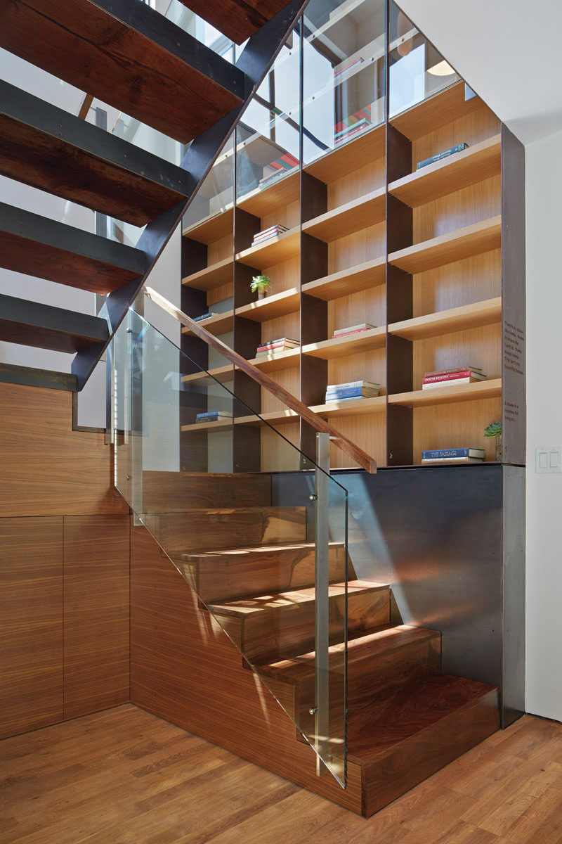 Stairs Design Ideas - 12 Examples Of Staircases With Bookshelves // These stairs and bookcase use a variety of materials including glass, steel and wood.