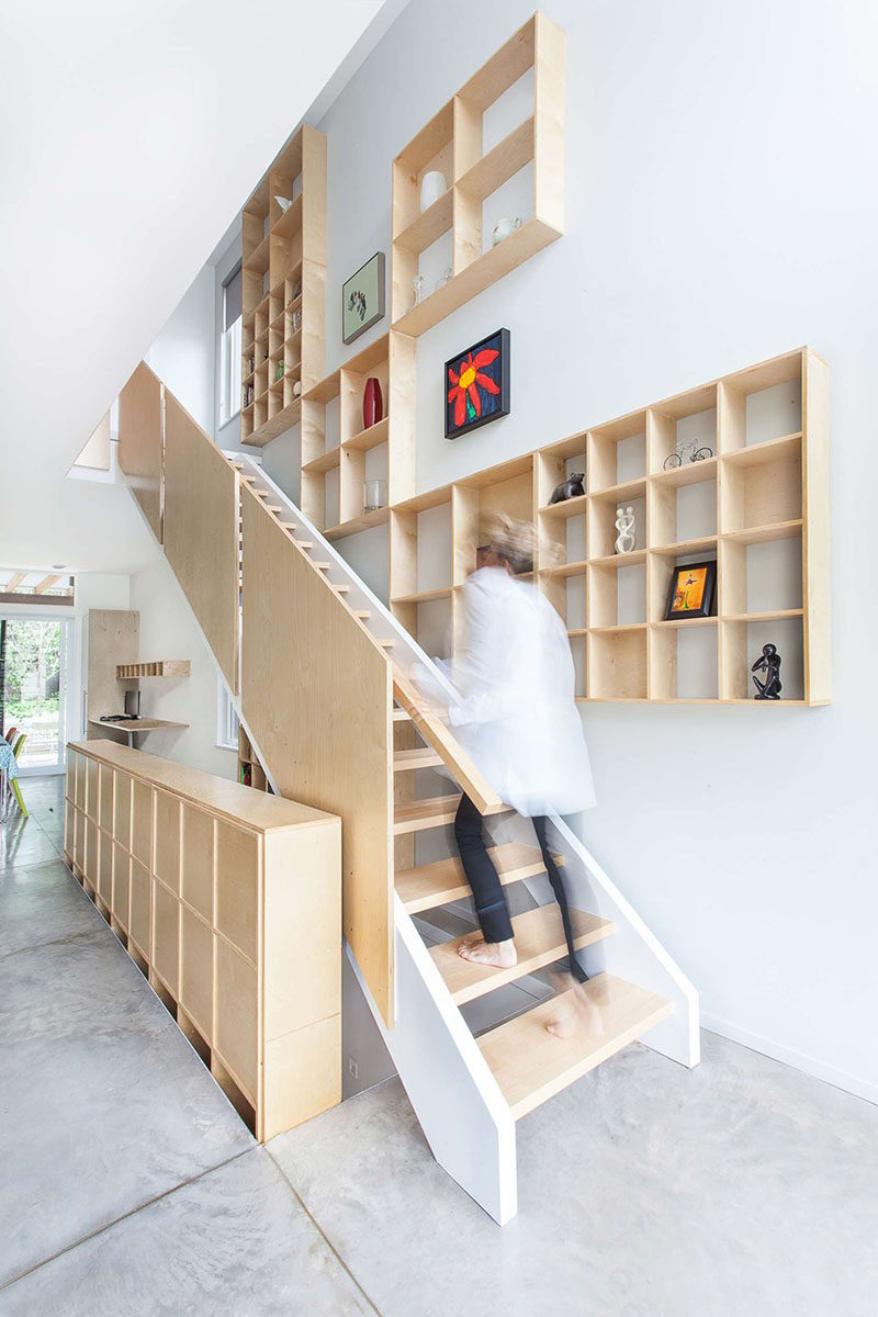 Stairs Design Ideas - 12 Examples Of Staircases With Bookshelves // These plywood shelves that follow the stairs up are a great place to store books and display art or other decorative items.