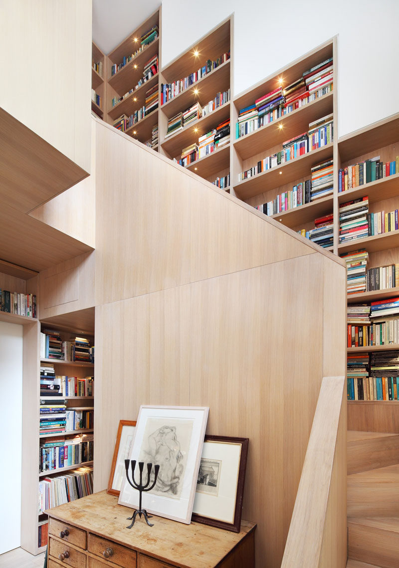 Stairs Design Ideas - 12 Examples Of Staircases With Bookshelves // This staircase/library combo is in the center of this London home, and small lights ensure that everything is on display.