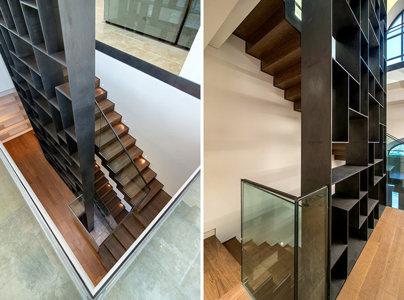 Stairs Design Ideas - 12 Examples Of Staircases With Bookshelves // This steel bookshelf travels upwards along side the stairs in this home.