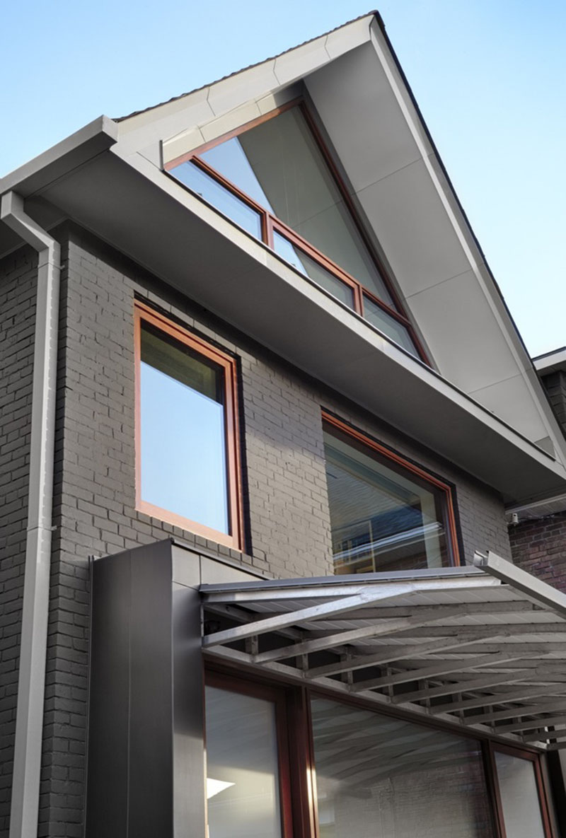 A Triangle Shaped Window Follows The Lines Of The Roof On This House