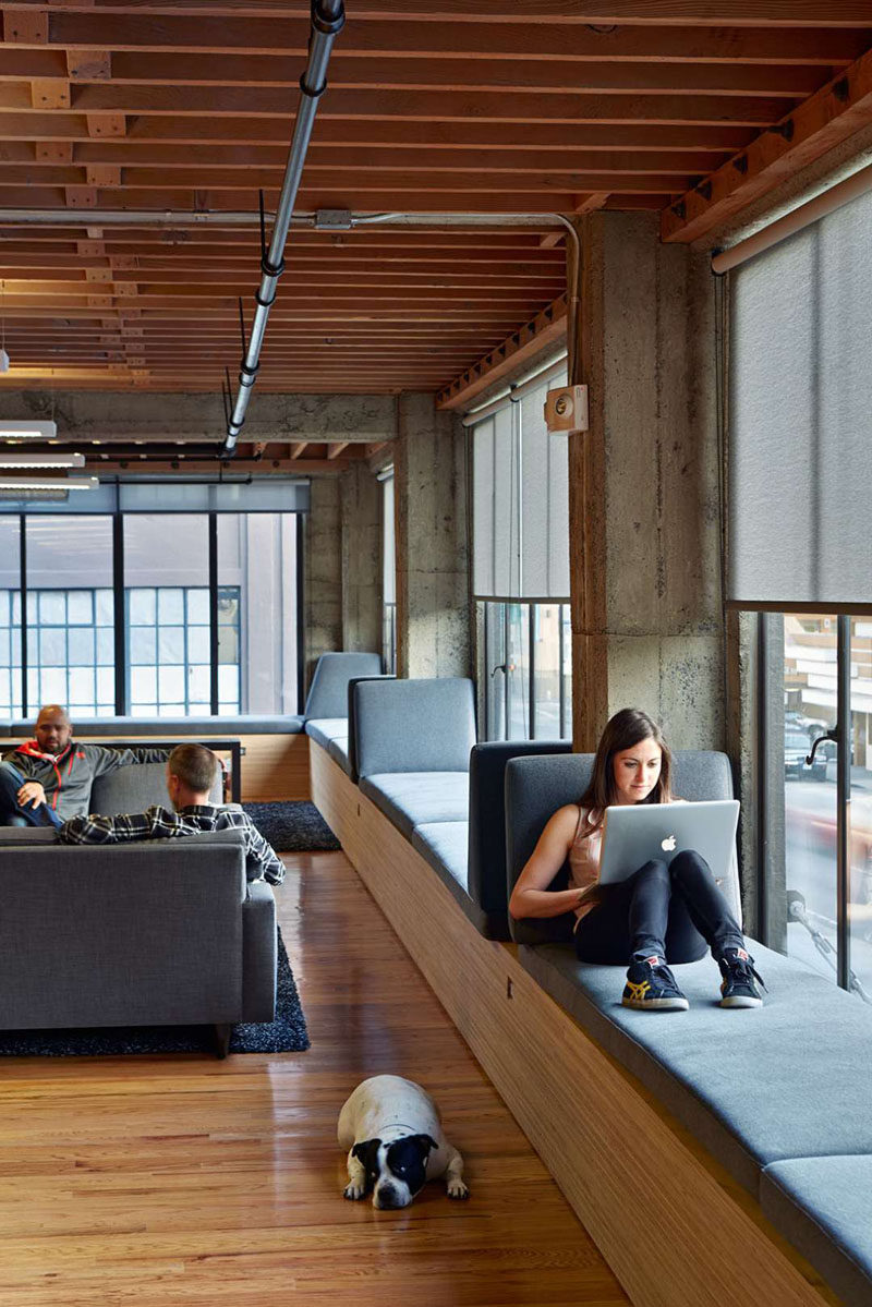 This workplace has roller shades to provide shade and reduce glare on computer screens.