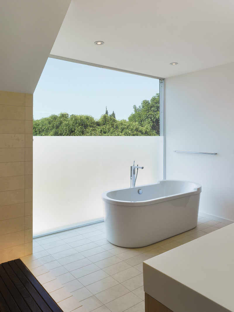 A partially frosted window creates privacy for a bathroom without blocking the light.