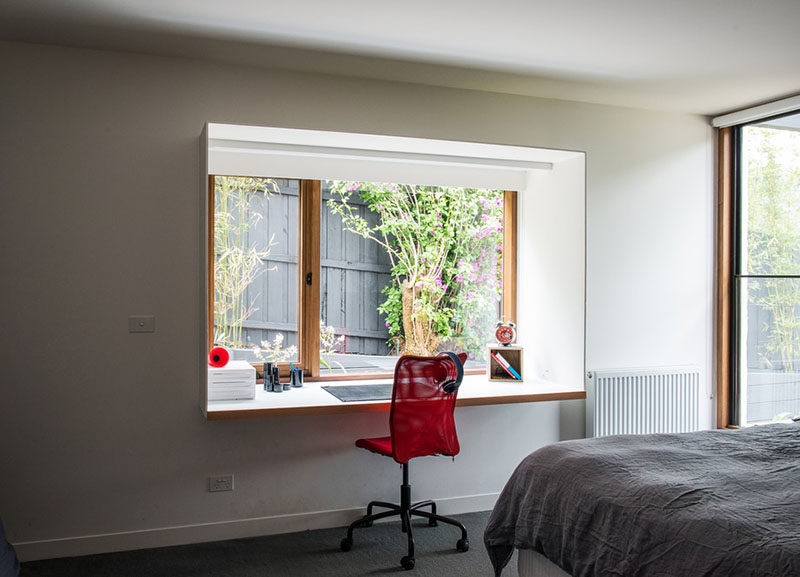 Small Home Office Design Idea - Steel boxes protrude from the bedrooms and create study areas within the rooms.