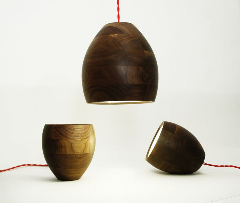 15 Wood Pendant Lights That Add A Natural Touch To Your Decor // These versatile lamps use wood pieces with inconsistent wood grains to create unique lights that can hang as pendants or sit on their side or bottom, to create different looks depending on where you want them.