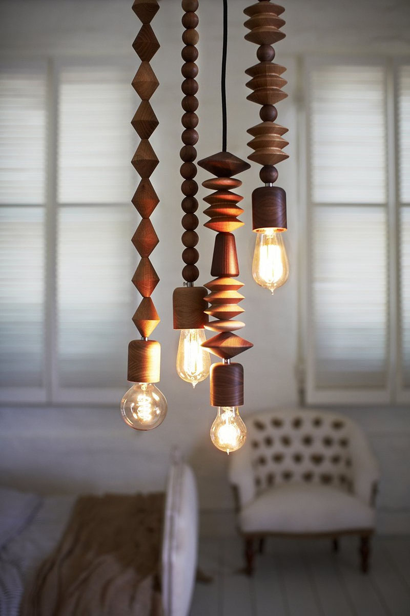 15 Wood Pendant Lights That Add A Natural Touch To Your Decor // Wood beads in various shapes and sizes make up these pendant lights.