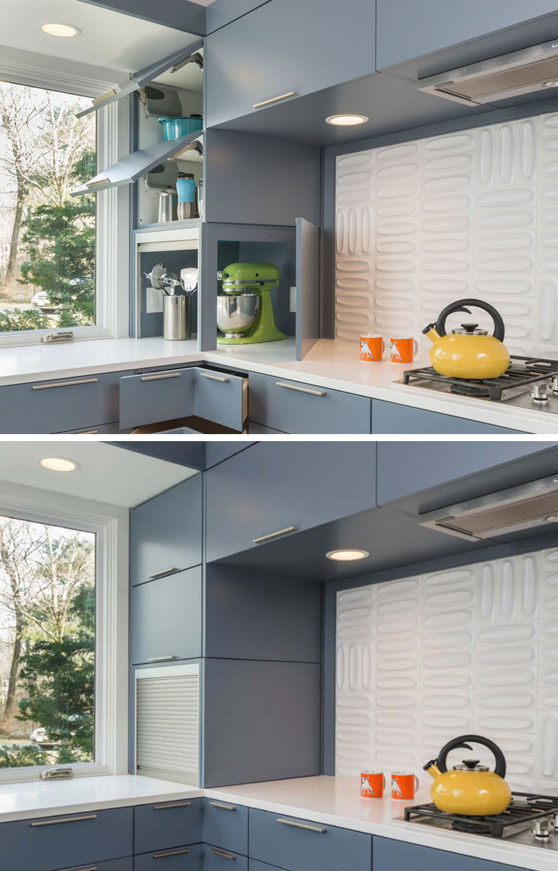 Kitchen Design Idea - Store Your Kitchen Appliances In A Dedicated Appliance Garage // The silver garage door slides up to reveal the inside of the appliance storage spot, while the blue cupboard door opens on the other side to provide even more access to the appliances when you need to use them.  #ApplianceGarage #KitchenIdeas #KitchenDesign