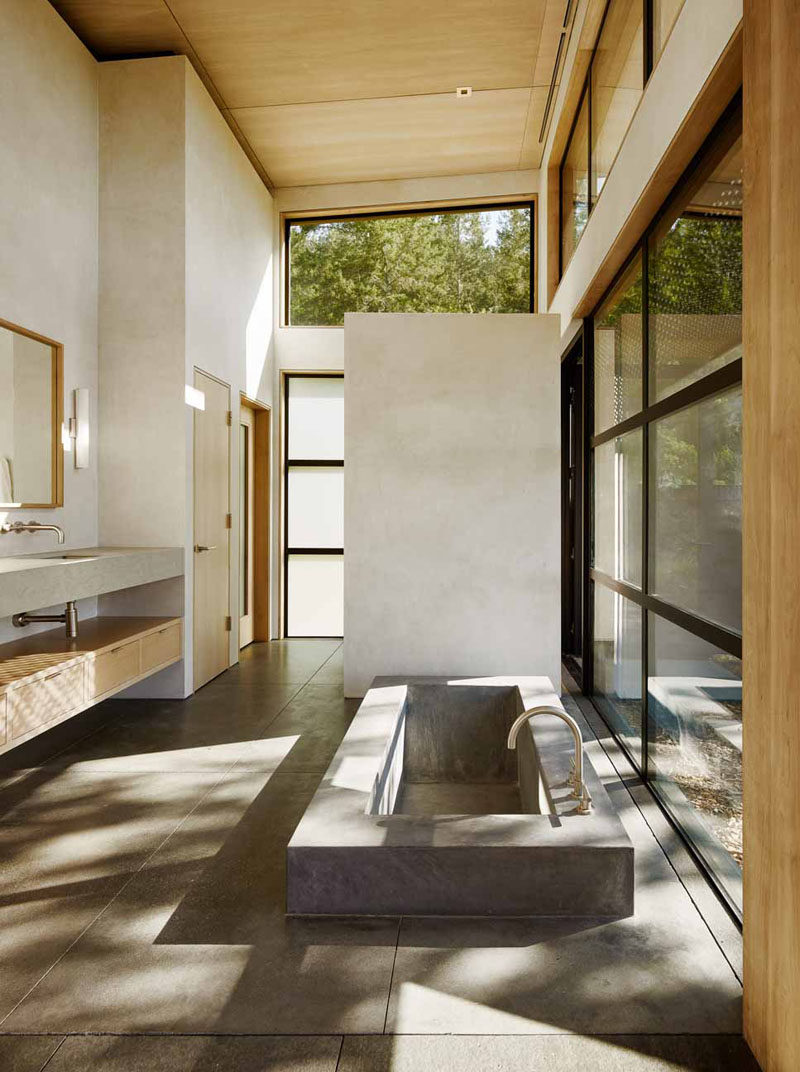 This bathroom has a sunken built-in concrete bathtub.