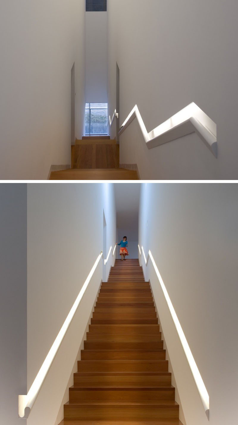 Stair Design Ideas - 9 Examples Of Built-In Handrails // This built-in handrail that runs the length of the stairs does double-duty as a light source. #BuiltInHandrail #HandrailIdeas #HandrailDesign #StairDesign #Handrails