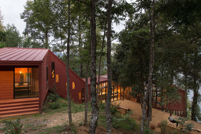 This House Is Designed With Various Levels Cascading Down A Forested Hillside