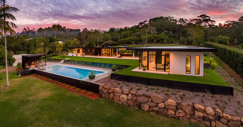 This contemporary Australian home has been designed for indoor/outdoor living and features a minimalist kitchen, outdoor lounge, a swimming pool with cabana and a landscaped yard