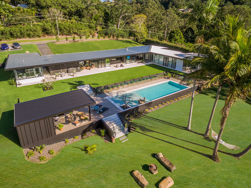This contemporary Australian home has been designed for indoor/outdoor living and features a minimalist kitchen, outdoor lounge, a swimming pool with cabana and a landscaped yard