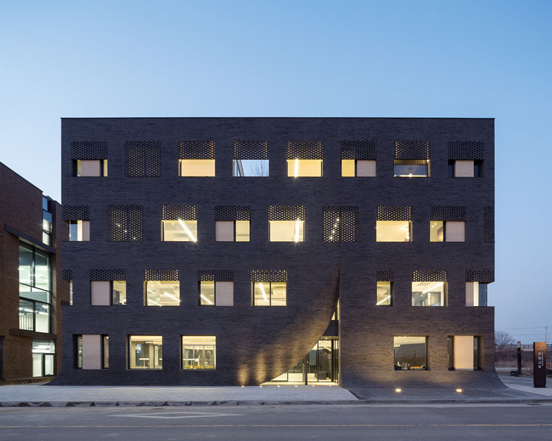 Wise Architecture have designed this building in Korea for MU:M, an English education company, that features a facade that looks as if it's being parted like a curtain to expose the entrance.