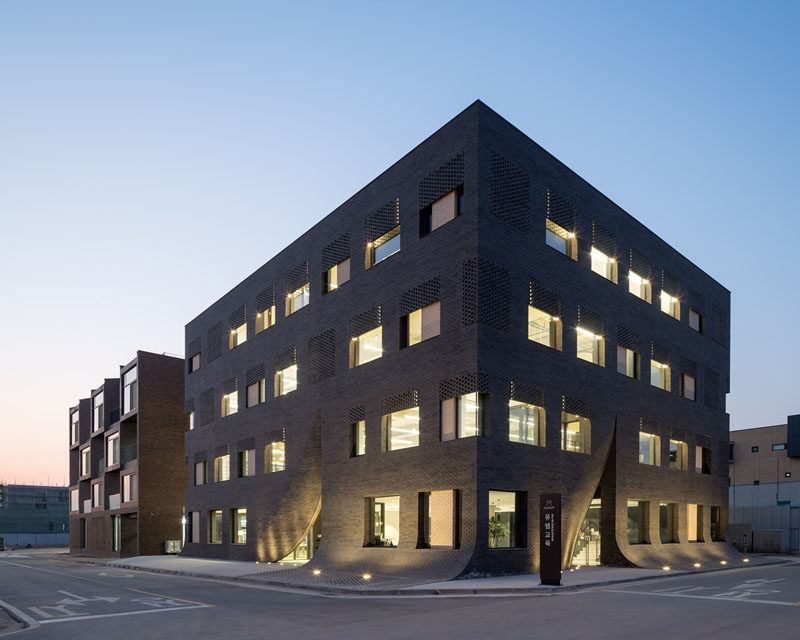 Wise Architecture have designed this building in Korea for MU:M, an English education company, that features a facade that looks as if it's being parted like a curtain to expose the entrance.