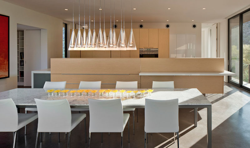 A collection of pendant lights help to anchor the dining table in this open space.