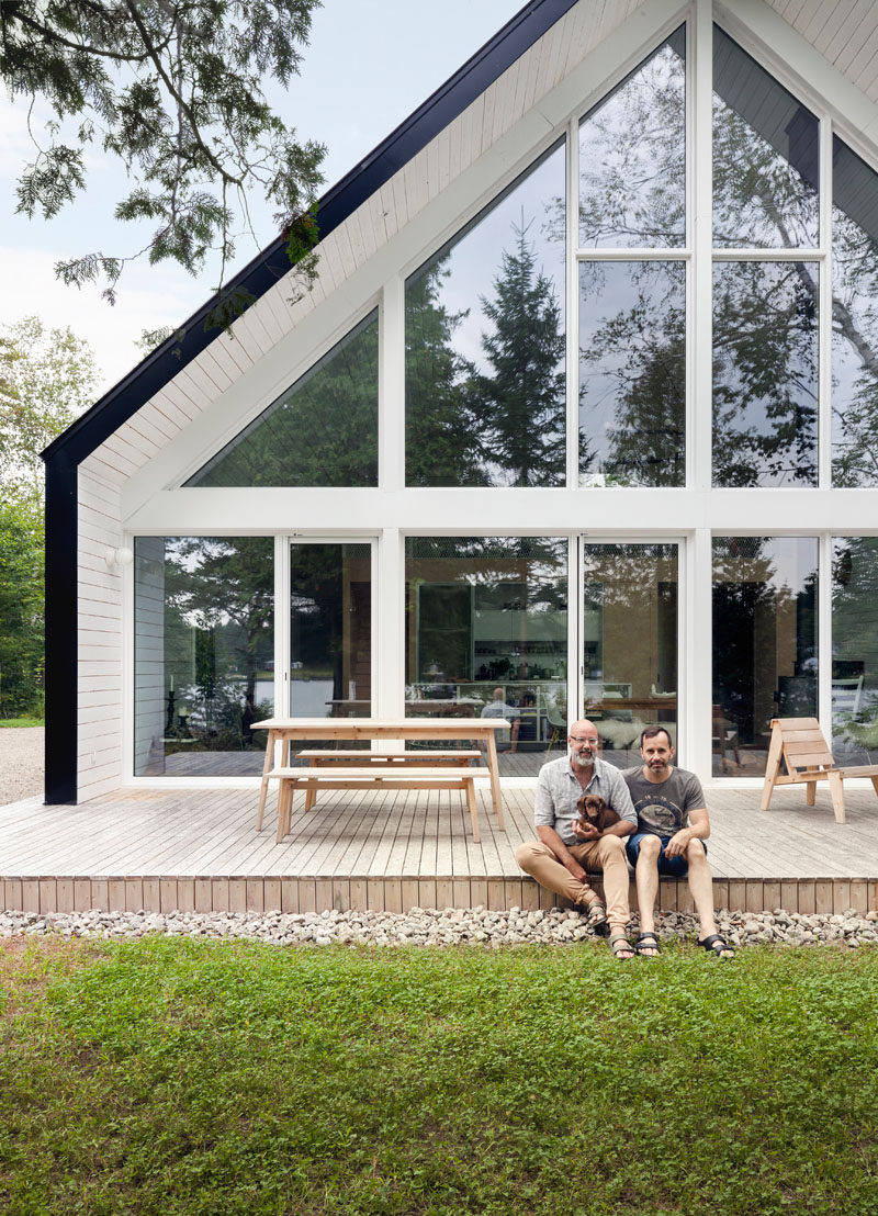 Outside this black and white chalet, there's a wooden deck with plenty of room for outdoor dining and entertaining.