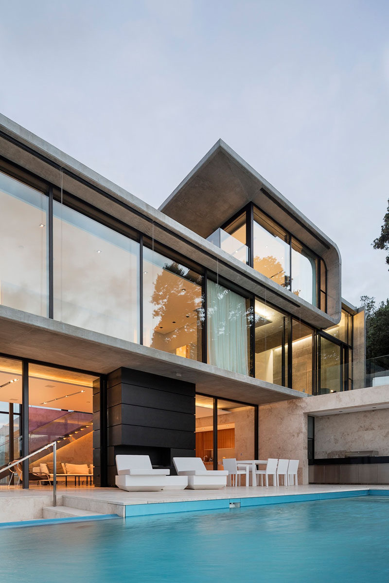 Multiple levels are tucked between curved concrete to create various platforms for living in this house.