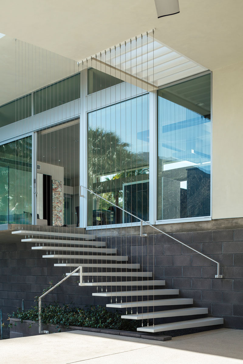 These exterior stairs lead you down from the main living area to an outdoor lounge and swimming pool, as well as the private master wing.