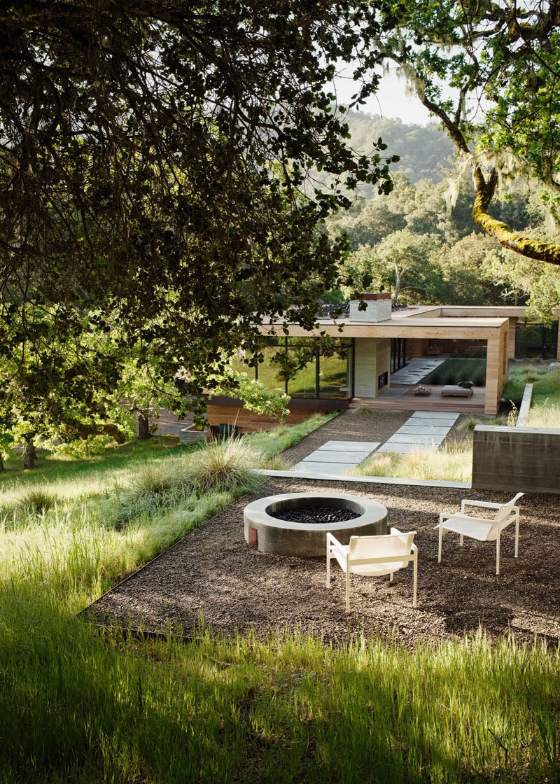 This home has a firepit that reached by a landscaped path.