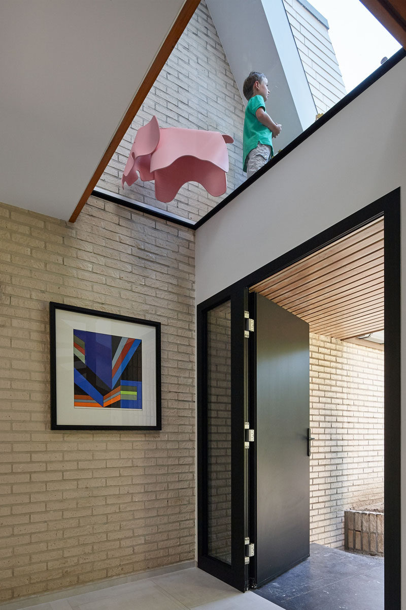 Just inside the front door of this renovated home, a skylight is now present to light up the entry of the home.